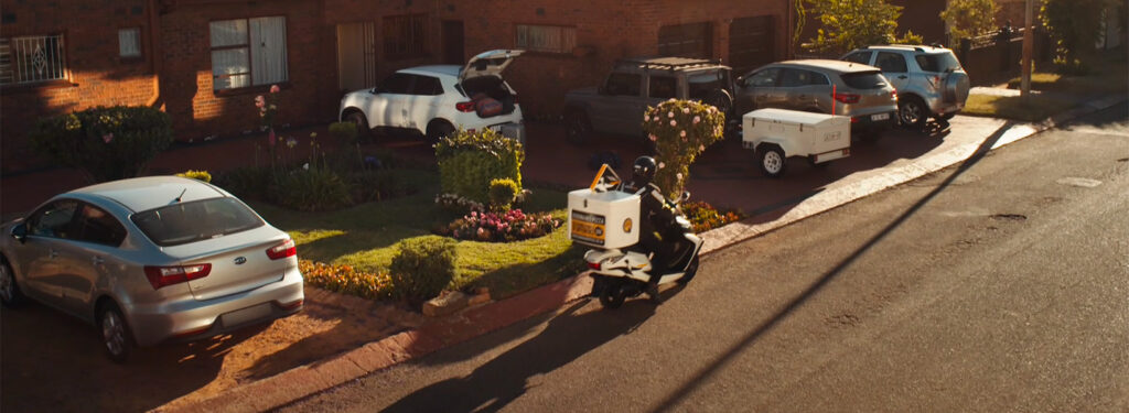 Pizza delivery bike in front of houses